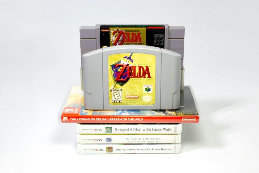 a nintendo game console sitting on top of a stack of books